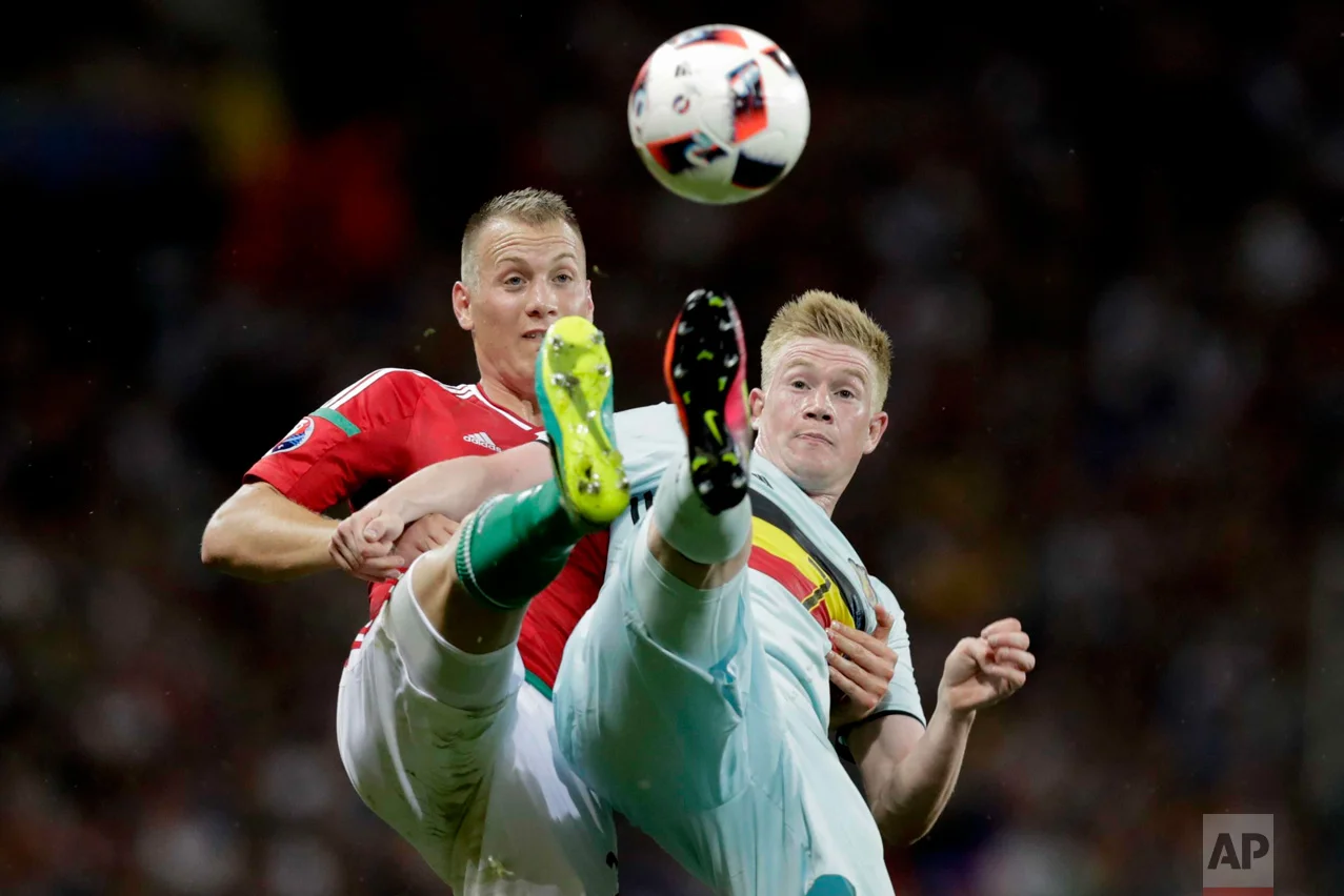 In this Sunday, June 26, 2016 photo, Belgium's Kevin De Bruyne, right, fights for the ball with Hungary's Adam Lang during the Euro 2016 round of 16 soccer match between Hungary and Belgium, at the Stadium municipal in Toulouse, France. (AP Photo/Ariel Schalit)