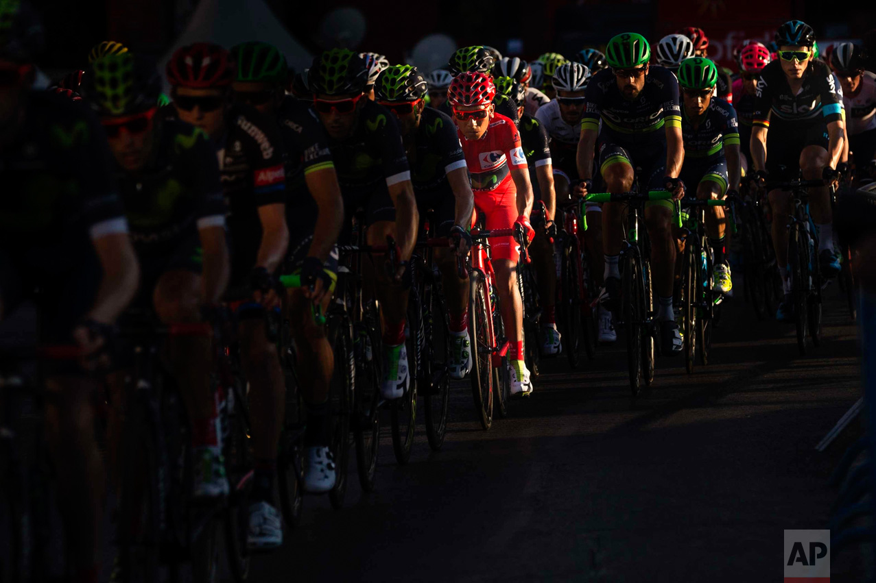  In this Sunday, Sept. 11, 2016 photo, Movistar's Team Nairo Quintna of Colombia rides wearing the overall red jersey rides to win the Spanish La Vuelta cycling tour that finished in Madrid, Spain. (AP Photo/Daniel Ochoa de Olza) 