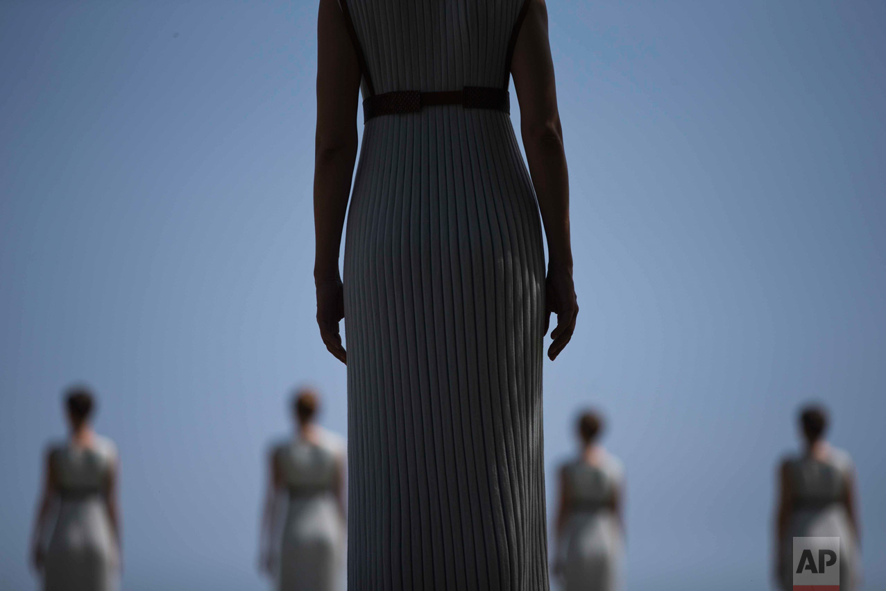  In this Wednesday, April 20, 2016 photo, High Priestess Katerina Lehou stands in front of a line of priestesses during the dress rehearsal for the lighting of the Rio Olympics flame, in Ancient Olympia, southern Greece. The meticulously choreographe