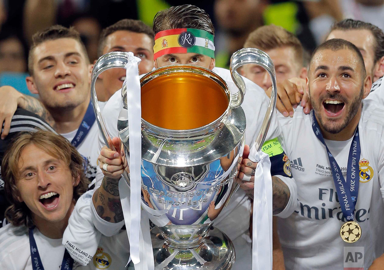  In this Saturday, May 28, 2016 photo, Real Madrid's Sergio Ramos celebrates with the trophy after the Champions League final soccer match between Real Madrid and Atletico Madrid at the San Siro stadium in Milan, Italy. (AP Photo/Manu Fernandez) 