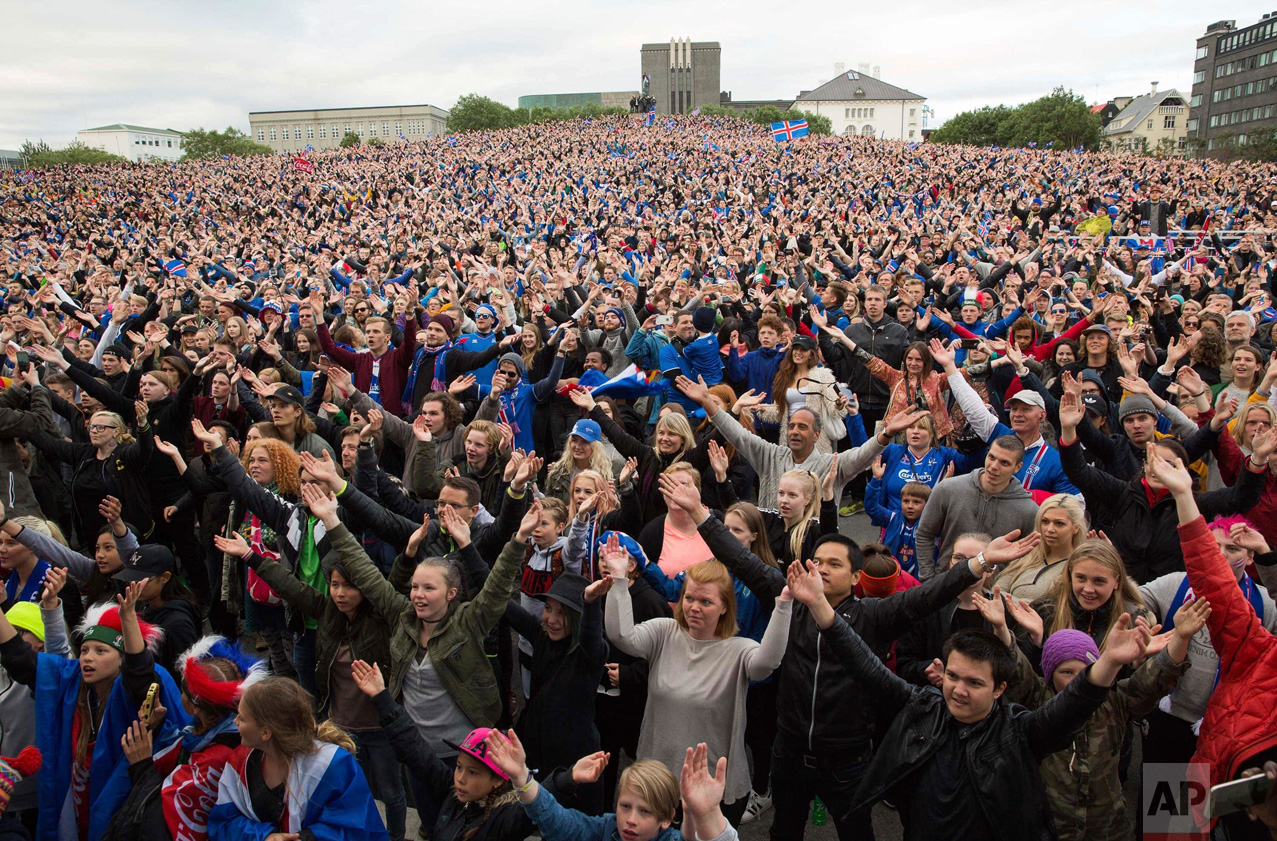  In this Monday June 27, 2016 photo, Icelandic soccer fans celebrate as they watch the Euro 2016 round of 16 match between Iceland and England shown on a screen in Reykjavik, Iceland. Iceland pulled off the shock of the European Championship by beati