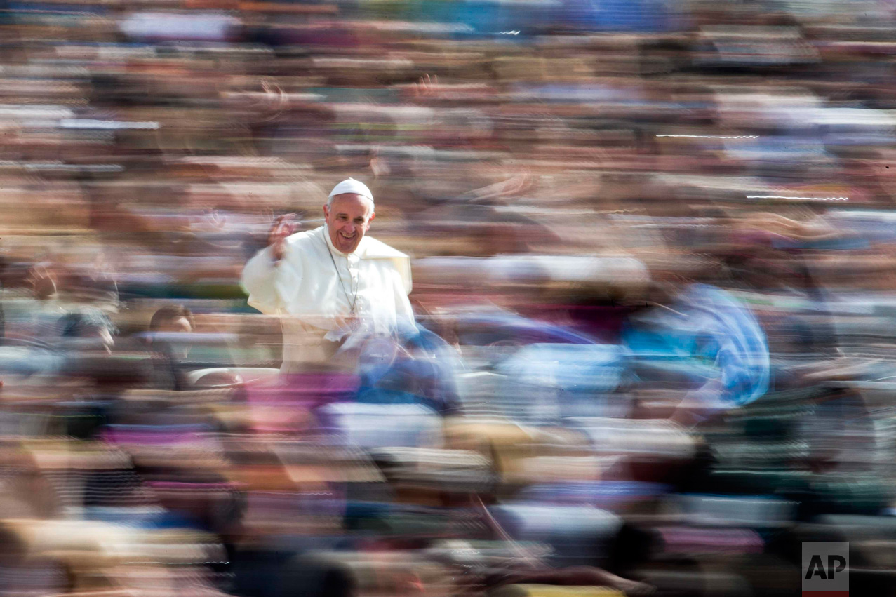  In this Wednesday, April 6, 2016 photo, Pope Francis waves to the crowd as he arrives on his pope-mobile for his weekly general audience, in St. Peter's Square at the Vatican. (AP Photo/Andrew Medichini) 