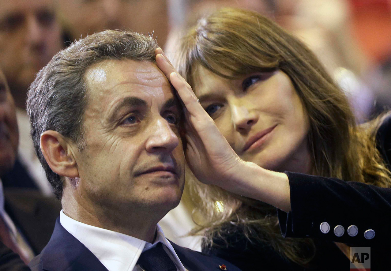  In this Thursday, Oct. 27, 2016 photo, Carla Sarkozy, right, caresses the brow of her husband, the former French President and candidate for France's conservative presidential primary, Nicolas Sarkozy, during a campaign meeting in Marseille, souther