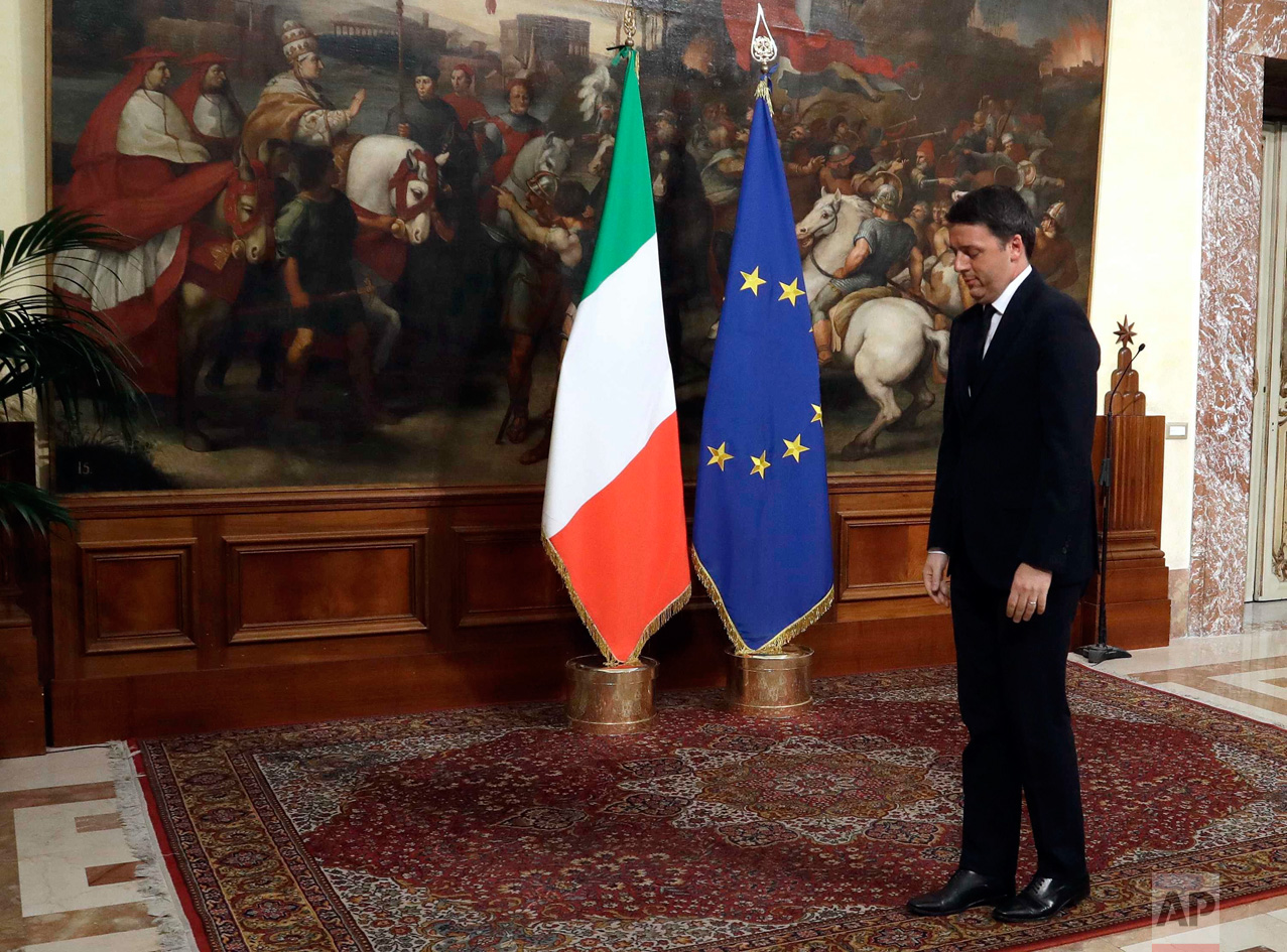  In this Monday, Dec. 12, 2016 photo, Italian outgoing Premier Matteo Renzi, right, waits for new Premier Paolo Gentiloni prior to the handover ceremony at Chigi Palace Premier's office, in Rome. Paolo Gentiloni, a Democrat serving as foreign ministe