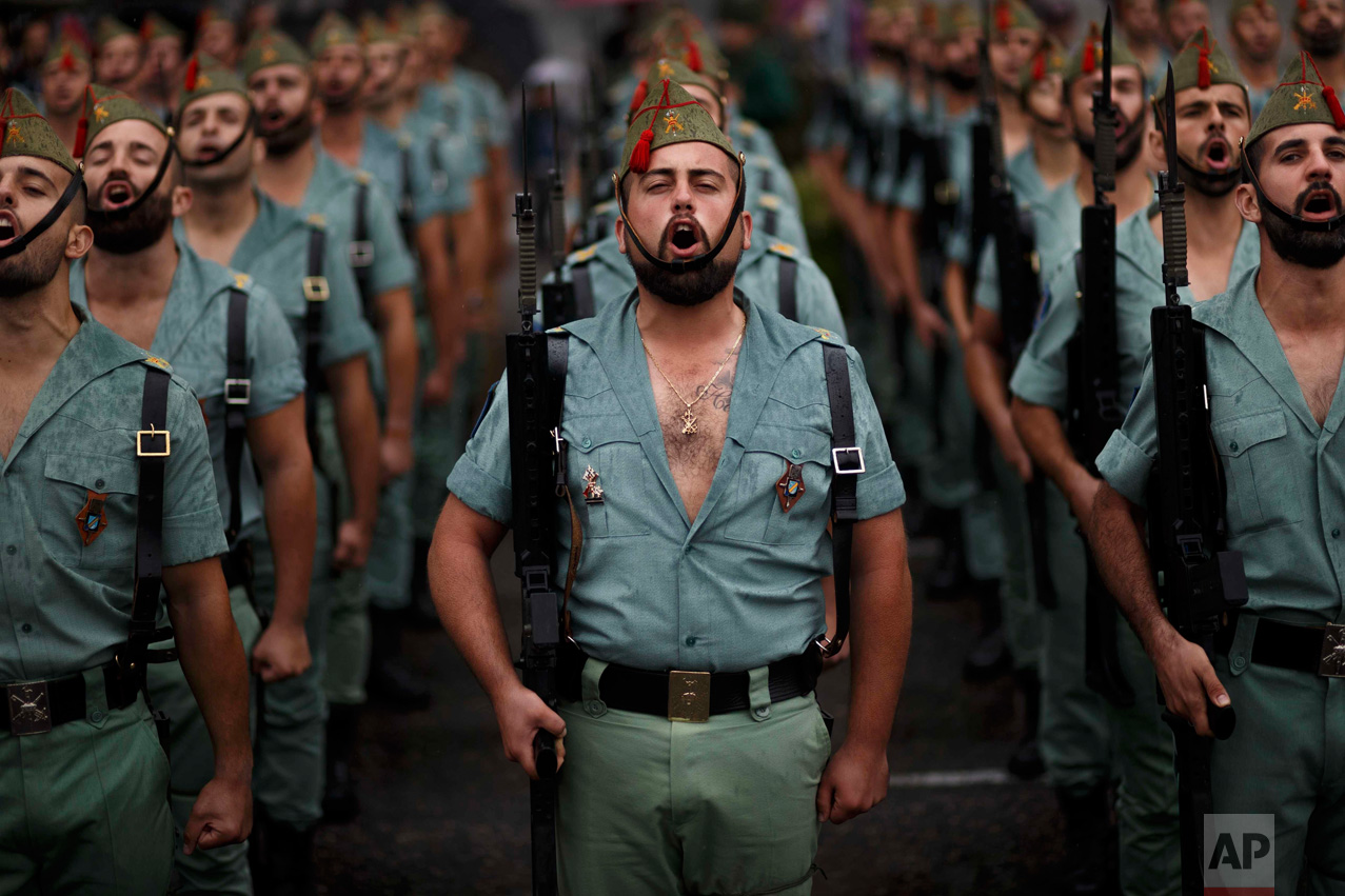  In this Wednesday, Oct. 12, 2016 photo, members of La Legion, an elite unit of the Spanish Army, sing during a military parade as they celebrate a holiday known as 'Dia de la Hispanidad' or Hispanic Day in Madrid. Almost a year into Spain's politica