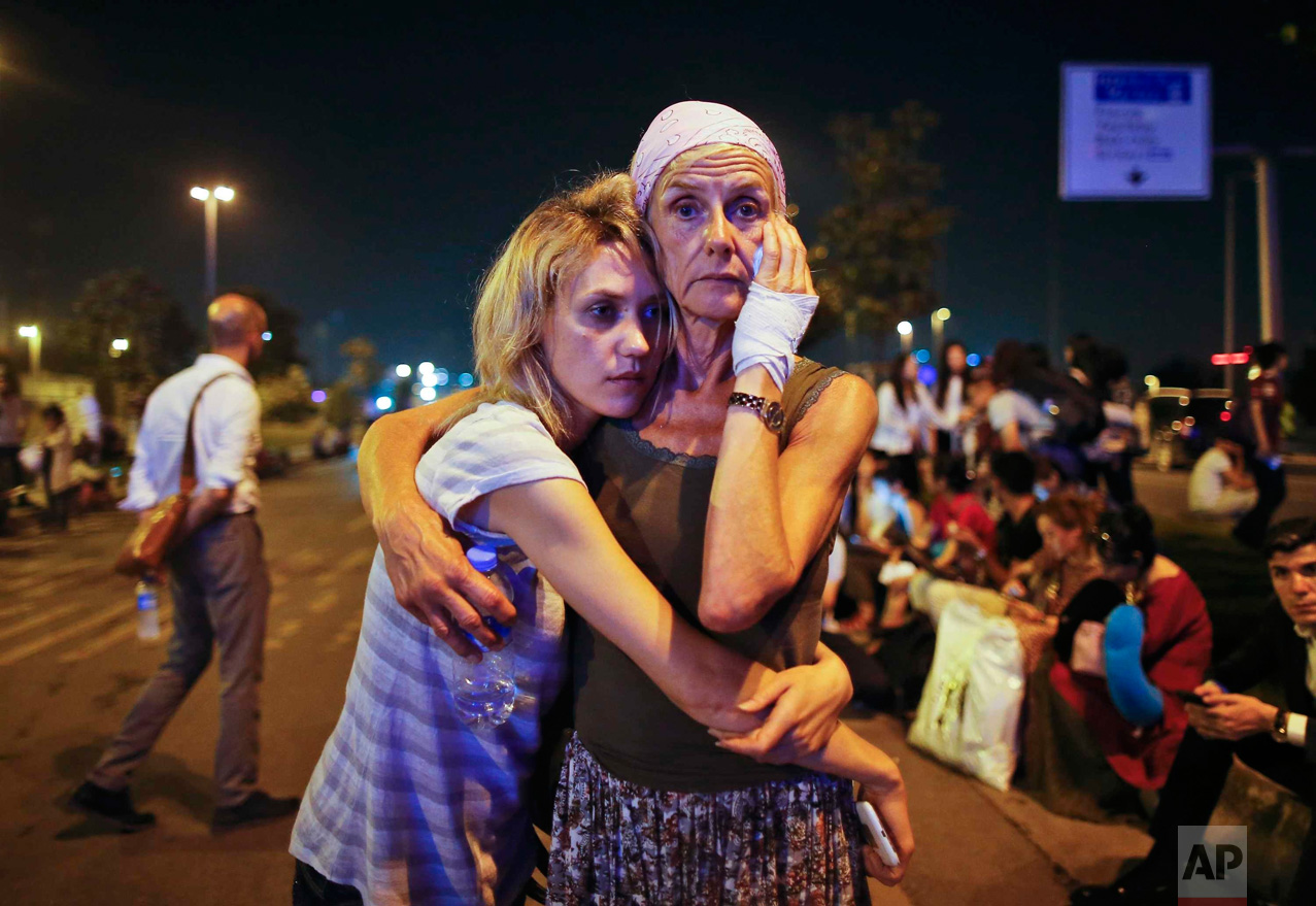 Passengers embrace each other as they wait outside Istanbul's Ataturk airport, on June 29, 2016, following their evacuation after a blast. Suspected Islamic State group extremists hit the international terminal of Istanbul's Ataturk airport, killing