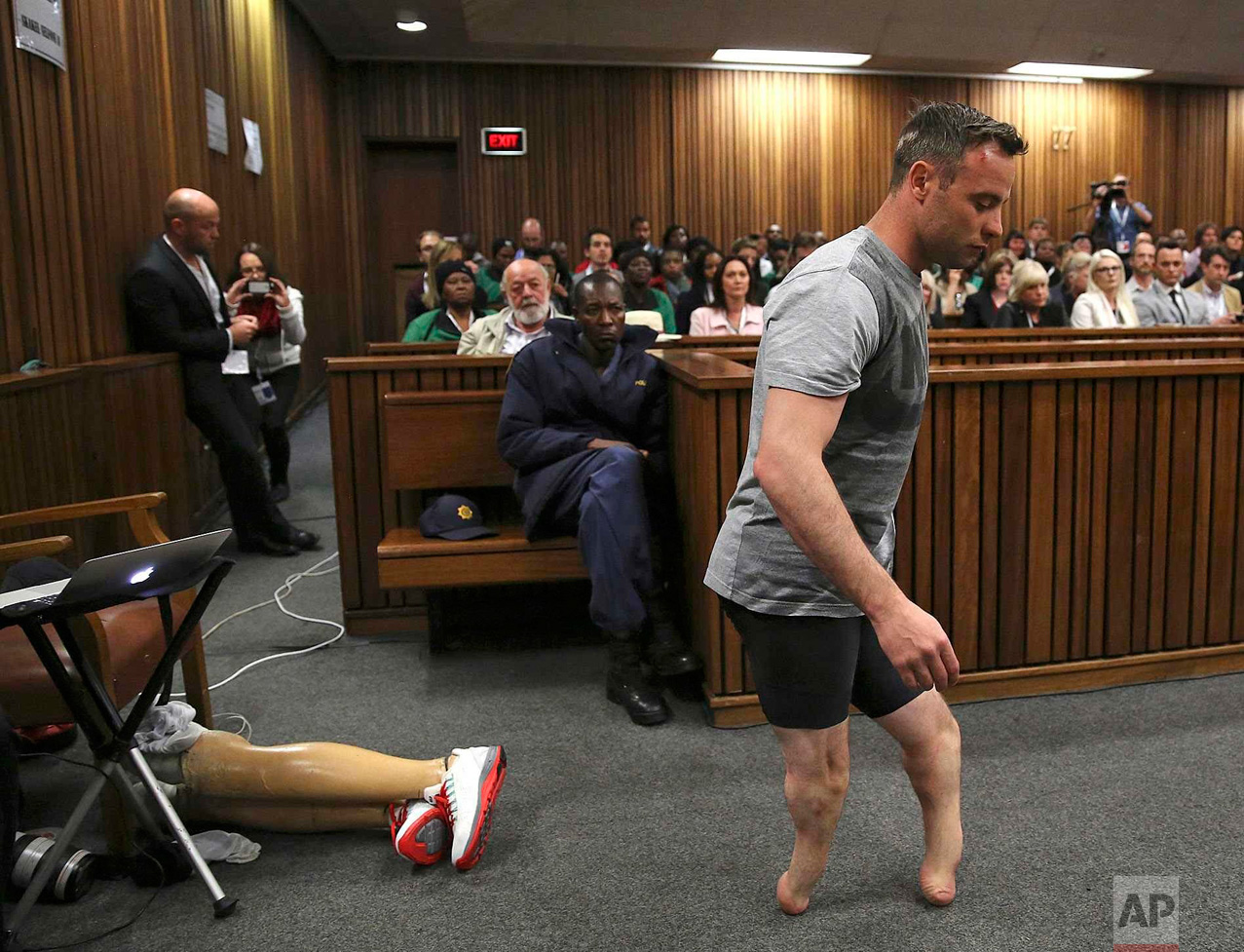  Oscar Pistorius' prosthetics lie on the floor as he walks on his amputated legs during argument in mitigation of sentence by his defense attorney Barry Roux in the High Court in Pretoria, South Africa, on June 15, 2016. An appeals court found Pistor