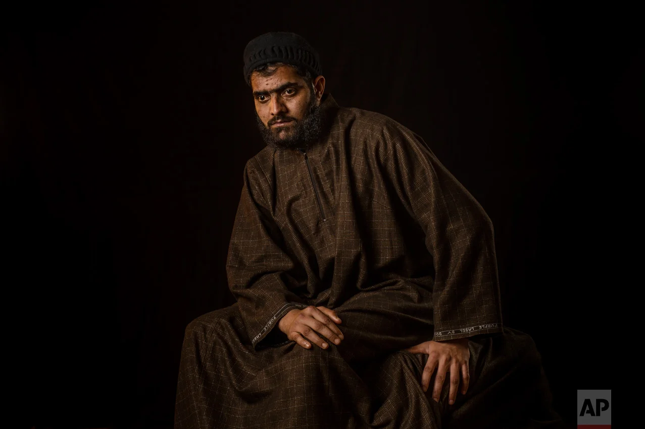 In this Dec. 1, 2016 photo, Firdous Ahmas Dar poses for a portrait in the village of Sopore, Indian-controlled Kashmir. Firdous, 25, a Kashmiri man who like many others lost vision in both eyes after Indian troops used shotguns to spray hundreds of metal pellets to quell an anti-India protest in the troubled Himalayan region. "I was the only bread earner of the family. It was my time to look after my old parents and my siblings, but now they have to look after me." (AP Photo/Bernat Armangue)