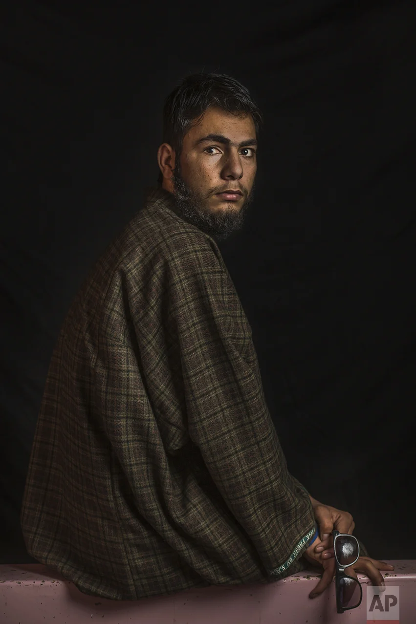 In this Dec. 1, 2016 photo, Nasir Fayaz Mir, 16, poses for a portrait in Pattan, Indian-controlled Kashmir. The most recent protests erupted in early July after Indian troops killed Burhan Wani, a young and charismatic militant commander and sparked off more than five months of angry street protests in the Kashmir valley. Health officials say that in the past five months more than 6,000 people, mostly young men, have been injured by shotgun pellets, including hundreds blinded in one or both eyes. Nasir was wounded in July and lost eyesight in his right eye. He has to wear sunglasses to protect his damaged eyes from the light and the dust. "I felt as the whole universe turned dark." (AP Photo/Bernat Armangue)