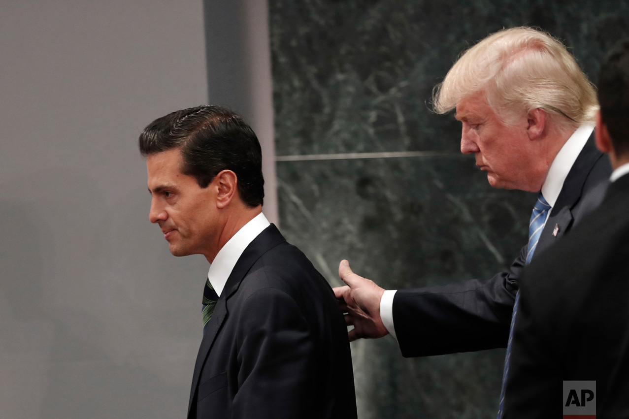  In this Aug. 31, 2016 photo, Republican presidential nominee Donald Trump walks with Mexico President Enrique Pena Nieto at the end of their joint statement at Los Pinos, the presidential official residence, in Mexico City. Trump called his surprise