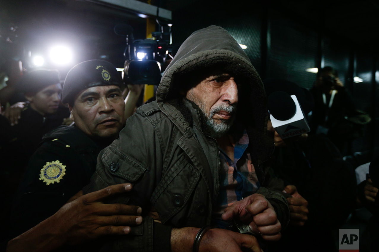  In this Jan. 12, 2016 photo, a handcuffed Brayan Jimenez, the former president of the Guatemalan football federation, is escorted by police into a courthouse in Guatemala City. Jimenez has been a fugitive for a month after Guatemala issued warrants 