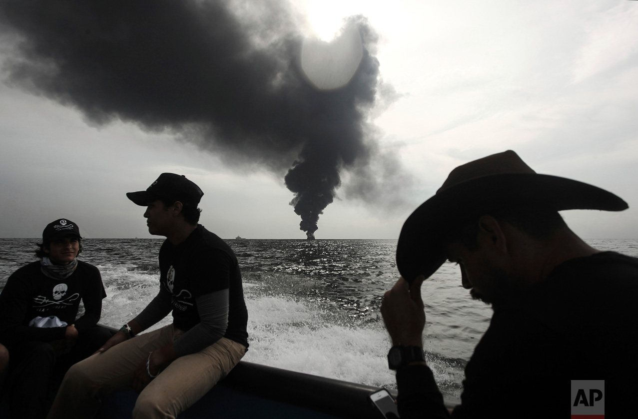  In this Sept. 25, 2016 photo, members of the marine wildlife conservation organization Sea Shepherd monitor the fuel tanker Burgos, as it continues to burn a day after it erupted in flames off the coast of the port city of Boca del Rio, Mexico. The 