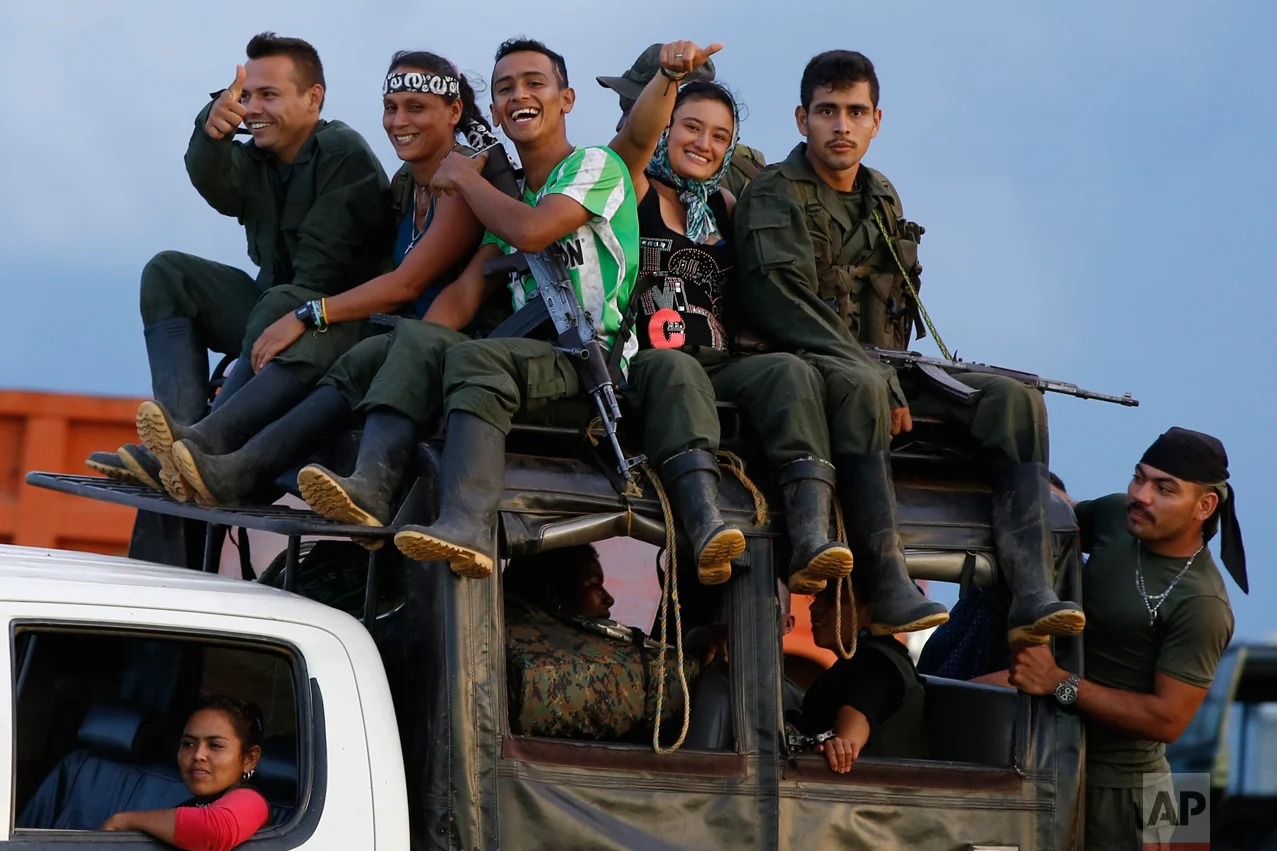 In this Sept. 16, 2016 photo, rebels of the Revolutionary Armed Forces of Colombia (FARC) arrive to El Diamante in southern Colombia. FARC rebels are gathered for a congress to discuss and vote on a peace accord reached with the Colombian government to end five decades of war. Historically secretive, this congress was the first one open to civilians. (AP Photo/Ricardo Mazalan)