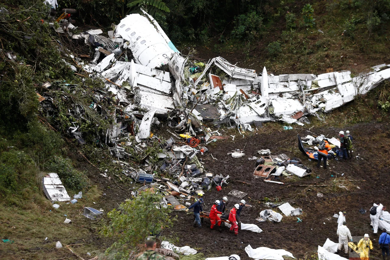 In this Nov. 29, 2016 photo, rescue workers recover a body from the wreckage site of an airplane crash, in La Union, a mountainous area near Medellin, Colombia. A LaMia jet carrying 77 people slammed into the Colombian mountainside just minutes after the pilot reported running out of fuel. The crash killed 71 of 77 aboard, including members of Brazil's Chapecoense soccer team and a group of journalists who were traveling to the Copa Sudamericana finals. (AP Photo/Fernando Vergara)