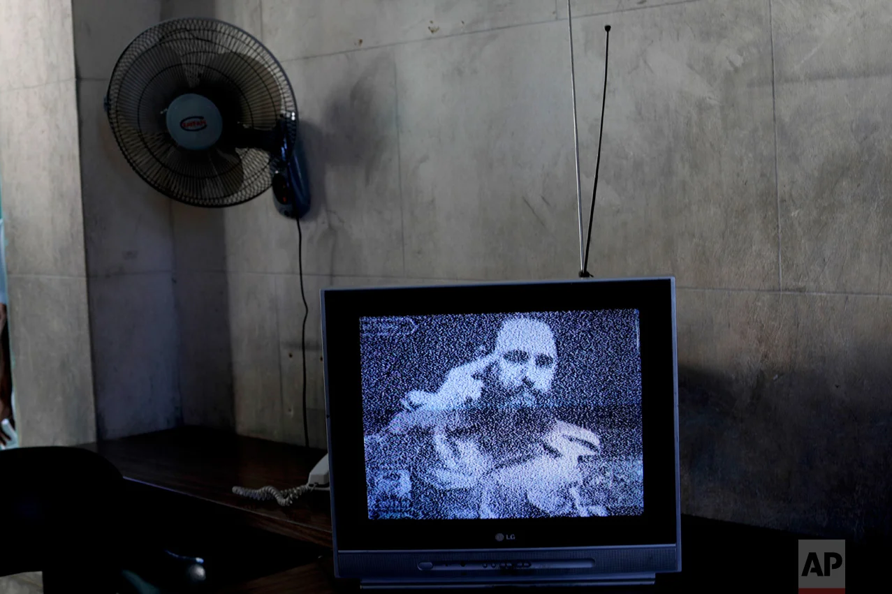 This Nov. 29, 2016 photo shows a television broadcasting black and white footage of Fidel Castro delivering a speech at a memorial in his honor in Guanabacoa on the outskirts of Havana, Cuba. With a shaking voice, President Raul Castro said on state television that his older brother died at 10:29 p.m. Friday, Nov. 25. He ended the announcement by shouting the revolutionary slogan: "Toward victory, always!" (AP Photo/Natacha Pisarenko)