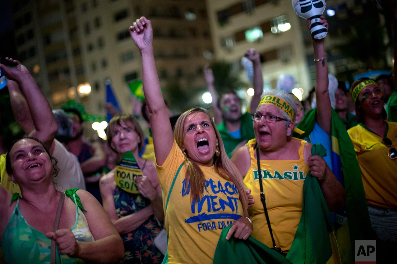 In this April 17, 2016 photo, anti-government demonstrators yell as they watch the vote count on a screen, as lawmakers vote on whether or not to impeach President Dilma Rousseff on Copacabana beach, in Rio de Janeiro, Brazil. The Chamber of Deputies approved the measure 367-137 and in May, the Senate voted 55-22 in favor. Rousseff was suspended and Vice President Michel Temer became interim president. (AP Photo/Silvia Izquierdo)
