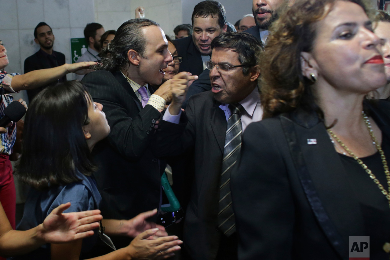  In this March 28, 2016 photo, government supporters argue with lawyers who came to the National Congress to show their support for the impeachment of Brazil's President Dilma Rousseff, in Brasilia, Brazil. As the economy worsened, hundreds of thousa