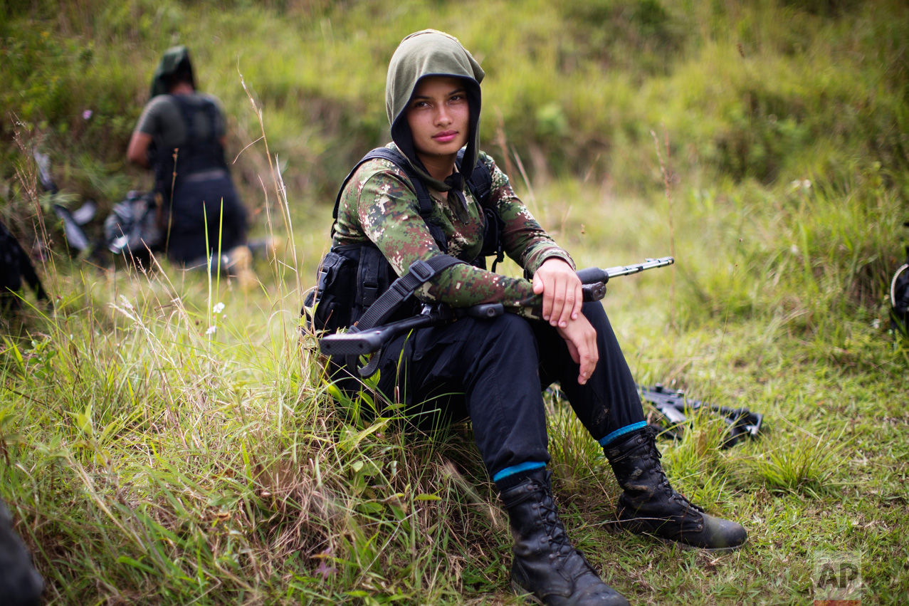  In this Jan. 6, 2016 photo, Juliana, a 20-year-old rebel fighter for the 36th Front of the Revolutionary Armed Forces of Colombia, or FARC, rests from a trek in the northwest Andes of Colombia, in Antioquia state. Like many of her comrades in arms, 