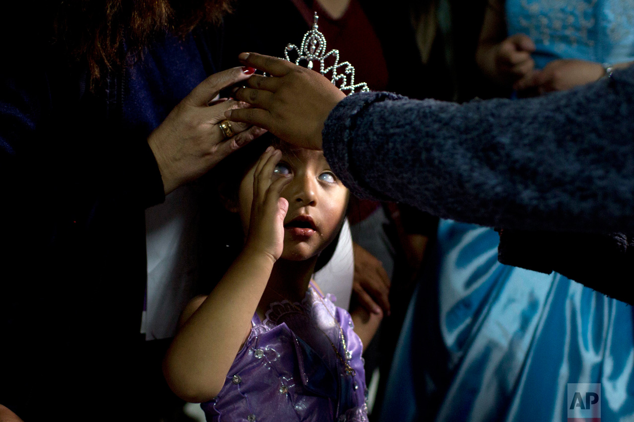  In this Oct. 14, 2016 photo, Mariela Flores, who is visually impaired, is crowned one of two Miss "Jacha Uru", translated from the Aymaran language as Great Day, in La Paz, Bolivia. The families of people with disabilities, with the help of the city