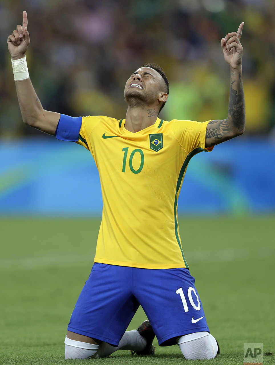  In this Aug. 20, 2016 photo, Brazil's Neymar weeps as he kneels down to celebrate after scoring the decisive penalty kick during the final match of the men's Olympic football tournament between Brazil and Germany at the Maracana stadium in Rio de Ja