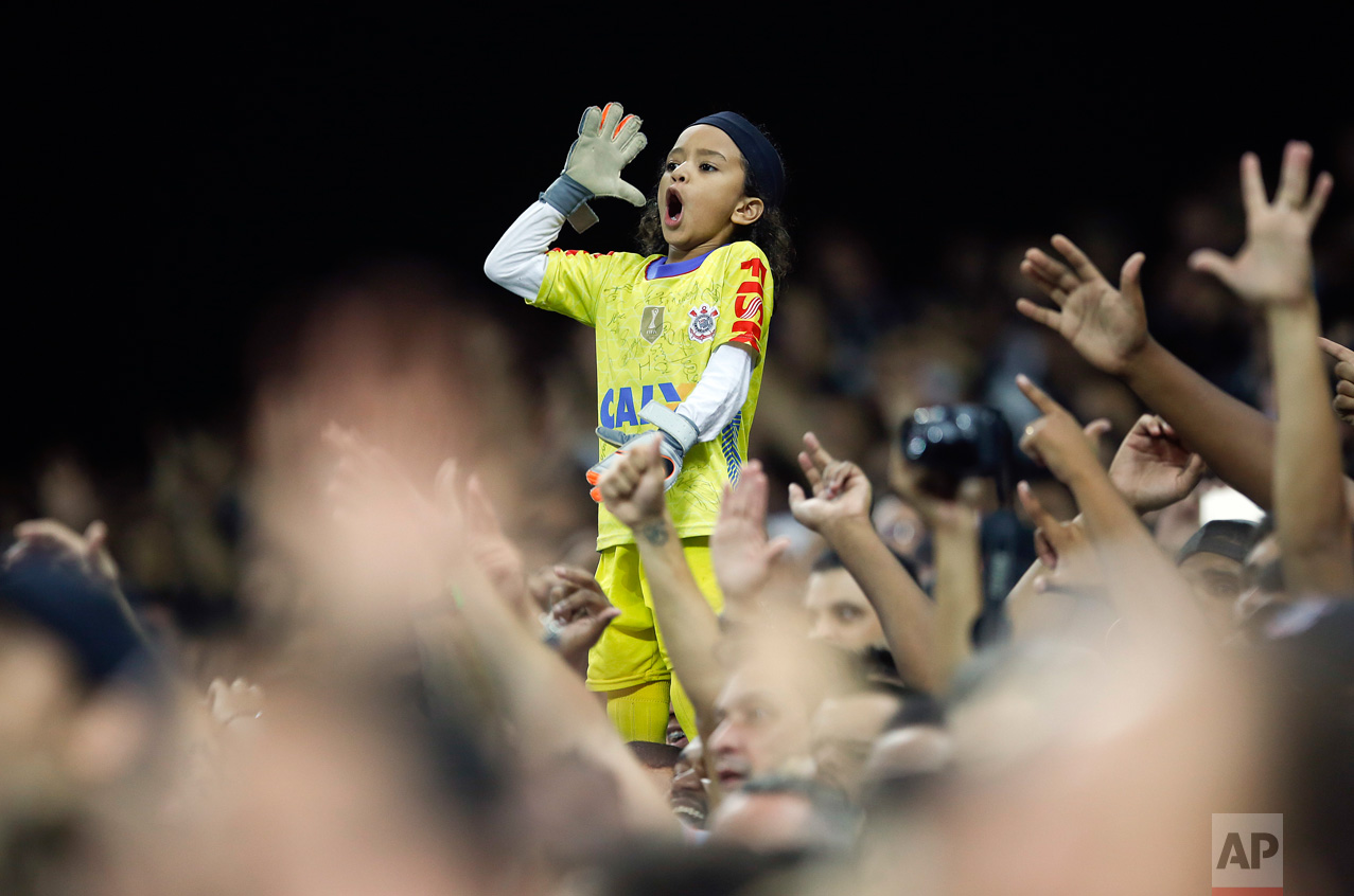  In this March 16, 2016 photo, a young fan of Brazil's Corinthians, dressed as the team's goalkeeper Cassio, cheers during a Copa Libertadores soccer match against Paraguay's Cerro Porteno in Sao Paulo, Brazil. (AP Photo/Andre Penner) 