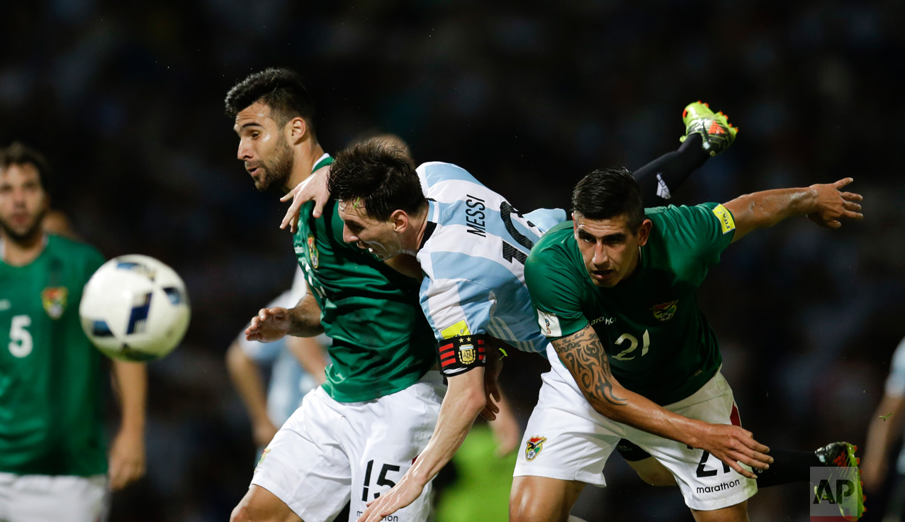  In this March 29, 2016 photo, Argentina's Lionel Messi, center, fights for the ball with Bolivia's Ronald Eguino, right, and Danny Bejarano during a 2018 World Cup qualifying soccer match in Cordoba, Argentina. (AP Photo/Natacha Pisarenko) 