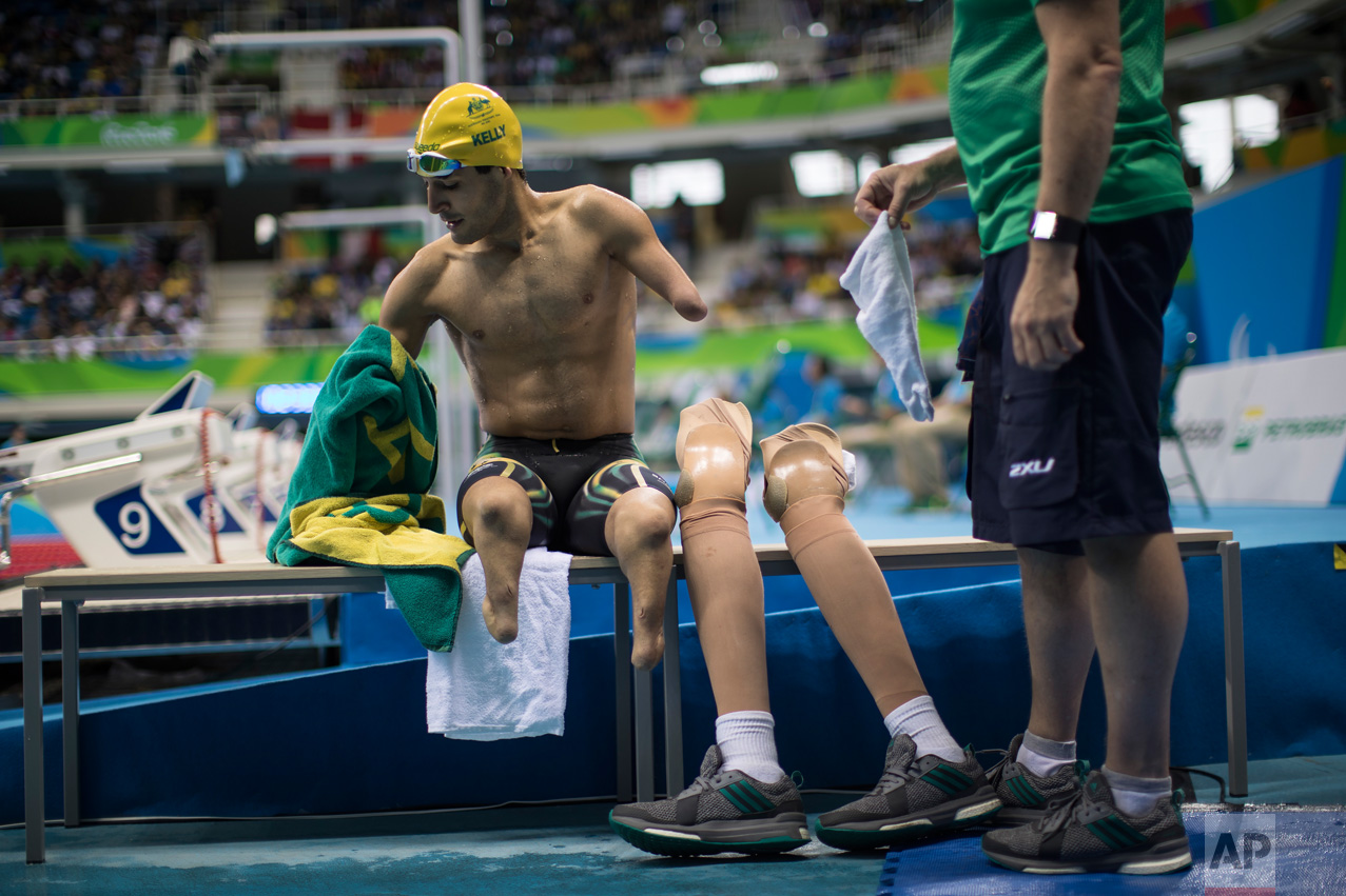  In this Sept. 16, 2016 photo, Australia's Ahmed Kelly sits before putting on his prosthetic legs after competing in the Men's 50m Backstroke S4 at the Paralympic Games in Rio de Janeiro, Brazil. (AP Photo/Felipe Dana) 