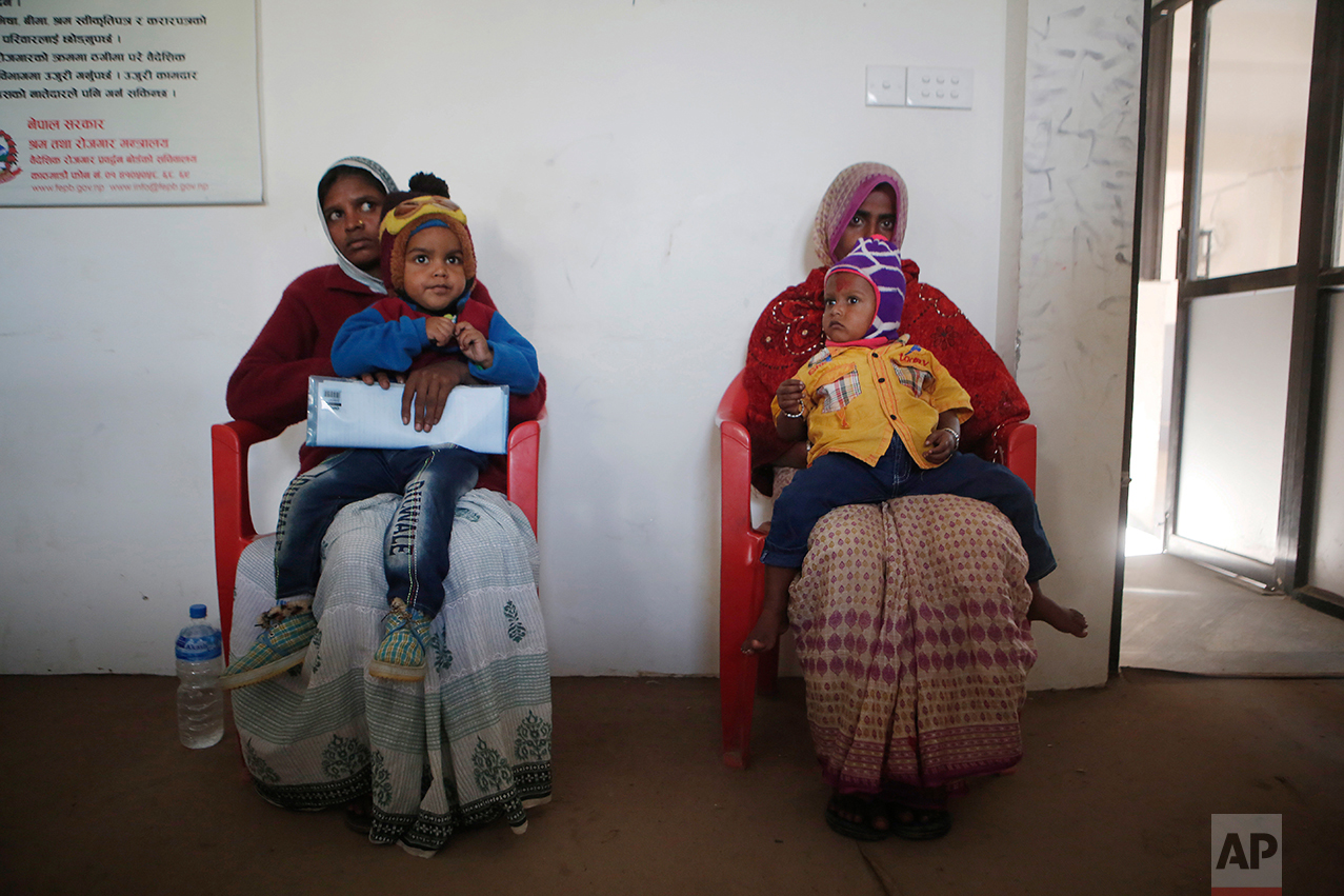 In this photo taken on Tuesday, Dec 20, 2016, Saro Kumari Mandal, 26, left, and Munni Devi, both wives of migrant workers who died in Qatar, sit with their sons on their laps as they wait at the Foreign Employment Promotion Board to receive compensation in Kathmandu, Nepal. The number of Nepali workers going abroad has more than doubled since the country began promoting foreign labor in recent years: from about 220,000 in 2008 to about 500,000 in 2015. Yet the number of deaths among those workers has risen much faster in the same period. In total, over 5,000 workers from this small country have died working abroad since 2008, more than the number of U.S. troops killed in the Iraq War. (AP Photo/Niranjan Shrestha)In this Wednesday, Nov. 23, 2016 photo, a woman breaks down after seeing the body of her son Balkisun Mandal Khatwe, a migrant worker who died in his sleep in Qatar, at Belhi village, in Saptari district, Nepal. The number of Nepali workers going abroad has more than doubled since the country began promoting foreign labor in recent years: from about 220,000 in 2008 to about 500,000 in 2015. Yet the number of deaths among those workers has risen much faster in the same period. But now medical researchers say these deaths fit a familiar pattern: Every decade or so, dozens, or even hundreds, of seemingly healthy Asian men working abroad in poor conditions start dying in their sleep. The suspected killer even has a name: Sudden Unexplained Nocturnal Death Syndrome. (AP Photo/Niranjan Shrestha)