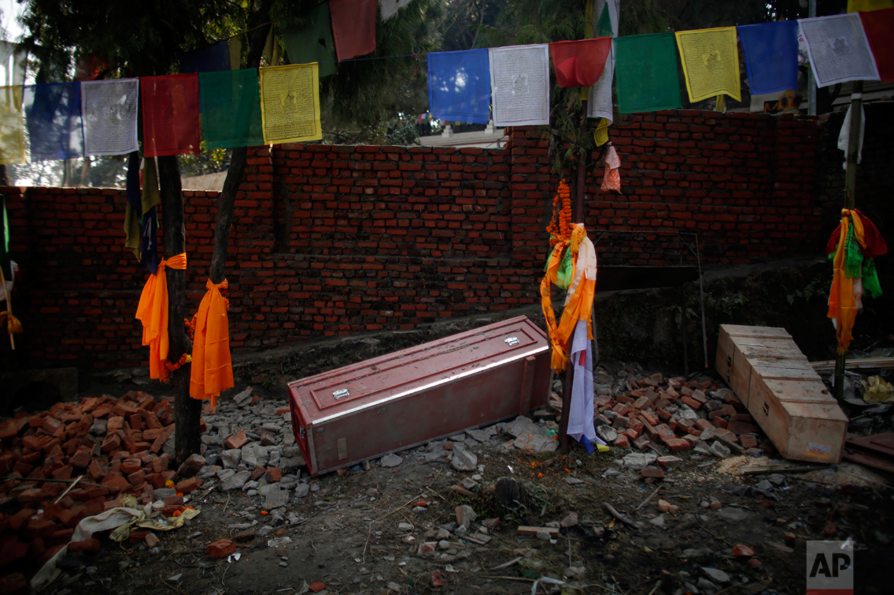 In this Monday, Nov. 29, 2016 photo, a red coffin that brought home the body of Nepali migrant worker from Saudi Arabia, lies on the ground empty after cremation rituals were completed at Swayambhunath stupa in Kathmandu, Nepal. The number of Nepali workers going abroad has more than doubled since the country began promoting foreign labor in recent years: from about 220,000 in 2008 to about 500,000 in 2015. Yet the number of deaths among those workers has risen much faster in the same period. In total, over 5,000 workers from this small country have died working abroad since 2008, more than the number of U.S. troops killed in the Iraq War. (AP Photo/Niranjan Shrestha)