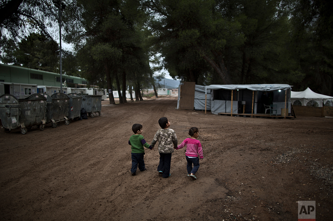  Syrian refugee children hold hands while walking in the refugee camp of Ritsona about 86 kilometers (53 miles) north of Athens, Wednesday, Dec. 28, 2016. &nbsp;(AP Photo/Muhammed Muheisen) 