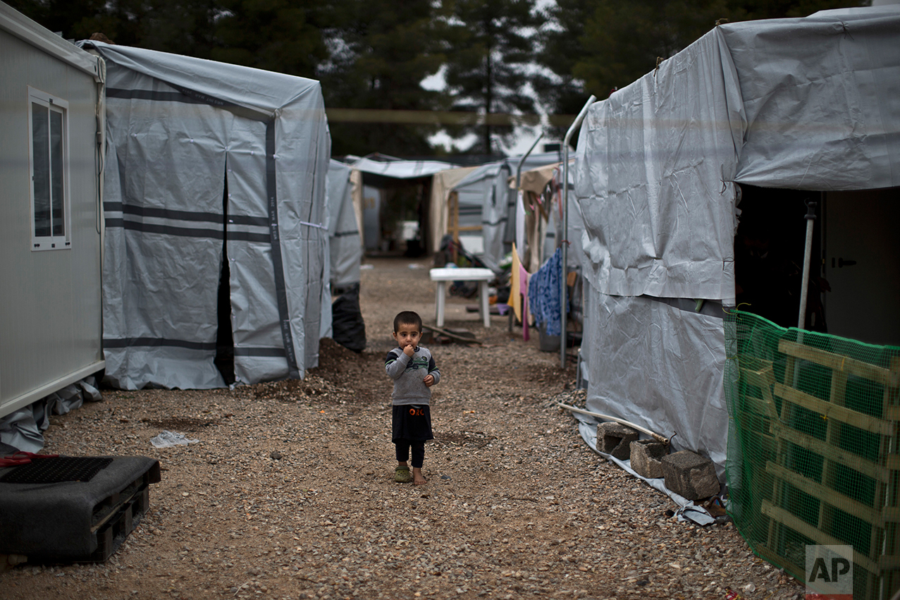  A Syrian refugee child walks between shelters at the refugee camp of Ritsona about 86 kilometers (53 miles) north of Athens, Wednesday, Dec. 28, 2016. (AP Photo/Muhammed Muheisen) 