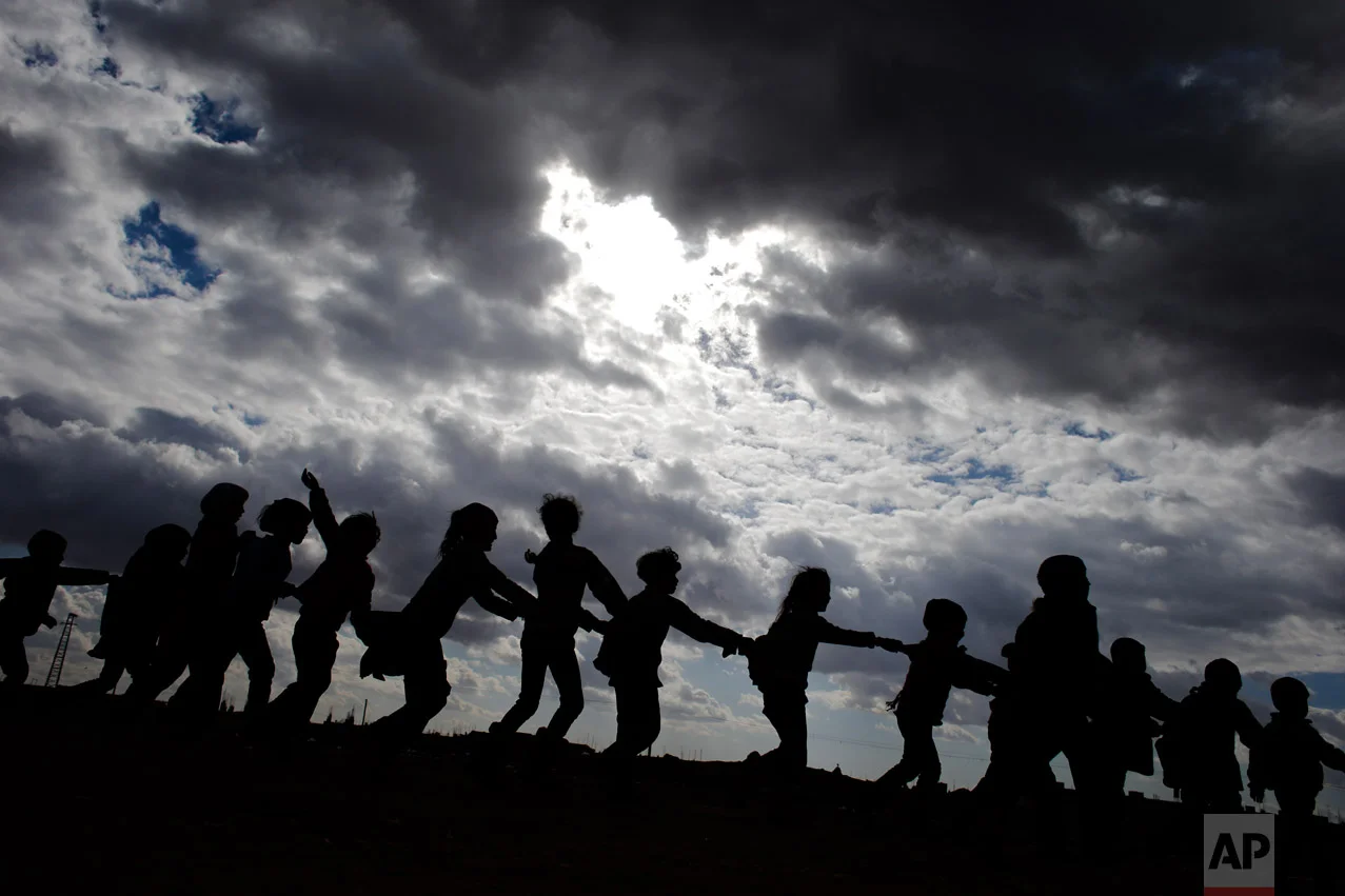 Syrian children who were displaced with their family from eastern Aleppo play in the village of Jibreen south of Aleppo, Syria, Saturday, Dec. 3, 2016. (AP Photo/Hassan Ammar)