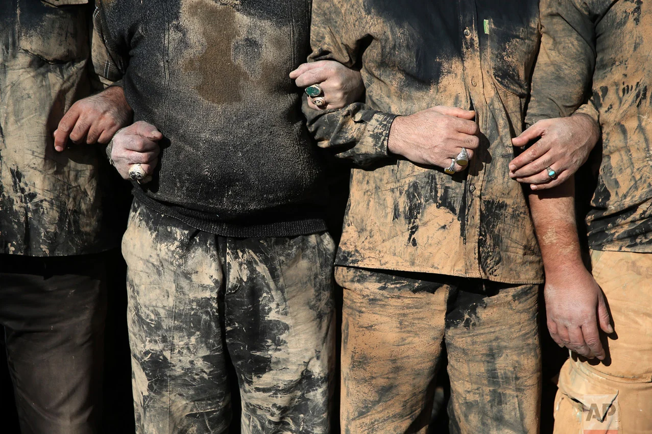 Iranian Shiite Muslims mourn after covering themselves with mud during Ashoura rituals, in Khorramabad, Iran, Wednesday, Oct.12, 2016. (AP Photo/Ebrahim Noroozi)