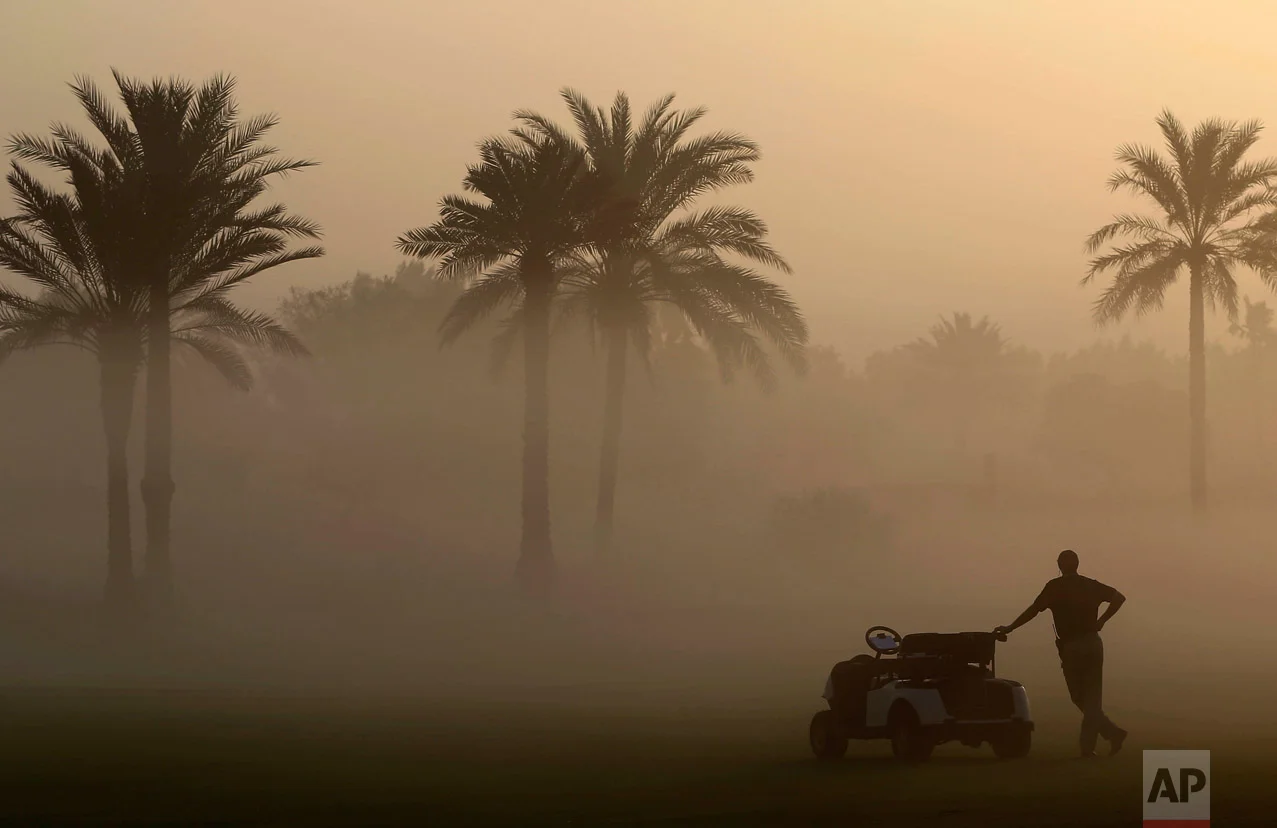A martial looks through the early morning fog which delayed the 1st round of Dubai Ladies Masters golf tournament in Dubai, United Arab Emirates, Wednesday, Dec. 7, 2016. (AP Photo/Kamran Jebreili)