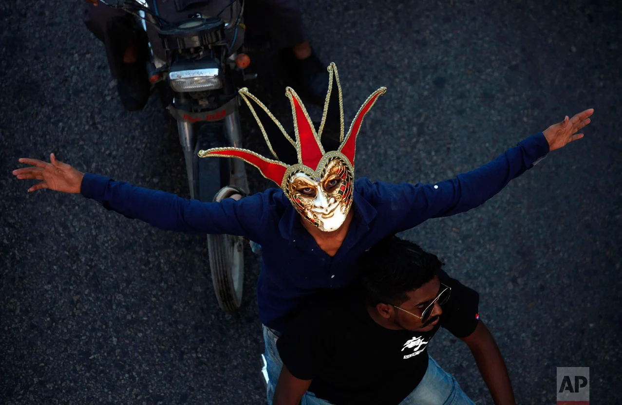 A Pakistani Christian wears mask while participating in a peace rally in connection with a Christmas celebration, in Karachi, Pakistan, Wednesday, Dec. 21, 2016. Although Pakistani Christians are in the minority, Christmas is a national holiday and is observed across the country as an occasion to celebrate. (AP Photo/Shakil Adil)