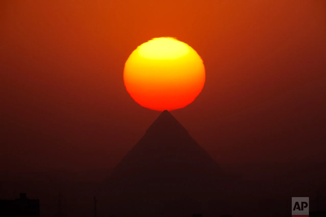 The sun sets over the the Giza Pyramids, near Cairo, Egypt, Friday, Aug. 19, 2016. (AP Photo/Amr Nabil)