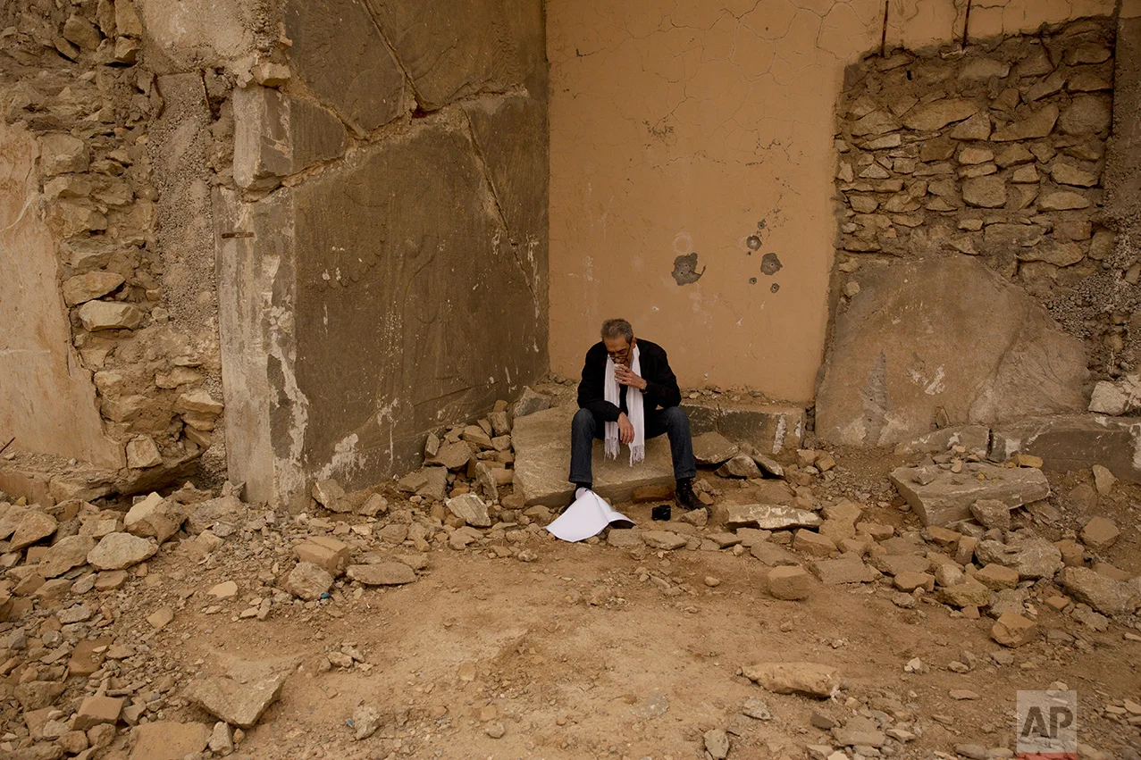 Sami Al-Khoja, a UNESCO official, pauses while participating in an assessment tour of the damage to the ancient site of Nimrud at the hands of Islamic State group militants in Iraq In this Wednesday, Dec. 14, 2016 photo. With the war against the militants still raging not far away, no one has been assigned to guard the site, much less catalogue what is left after IS blew up its ancient palaces and carved apart and smashed its elaborate reliefs. (AP Photo/Maya Alleruzzo)