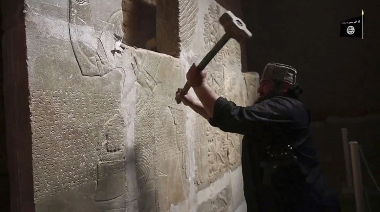This image made from video posted online by Islamic State militants in April 2015 shows a militant taking a sledgehammer to a stone carving at the ancient site of Nimrud near Mosul, Iraq. Militants blew up and hacked apart much of the nearly 3,000-year-old city’s remains, destroying one of the Mideast’s most important archaeological sites. Nearly a month after the extremists were driven out, the site is still in danger, with the wreckage unprotected and vulnerable to being stolen. (Militant video via AP)