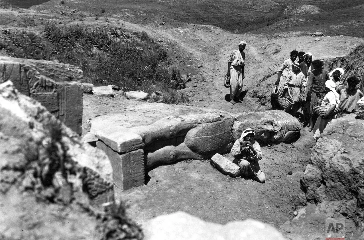 People gather around the partially-unearthed statue of a lamassu, a great winged bull protective deity, in this undated photo taken by British mystery writer Agatha Christie at the ancient site of Nimrud in northern Iraq. The lamassus at the palace gates were among the works destroyed by IS militants in 2015. Christie’s grandson, Matthew Prichard, says she would be heartbroken by the destruction, saying if she and her husband Max Malloran, were alive to see it, “they would not have recognized the places where they had been and lived and worked.” (Agatha Christie via AP)