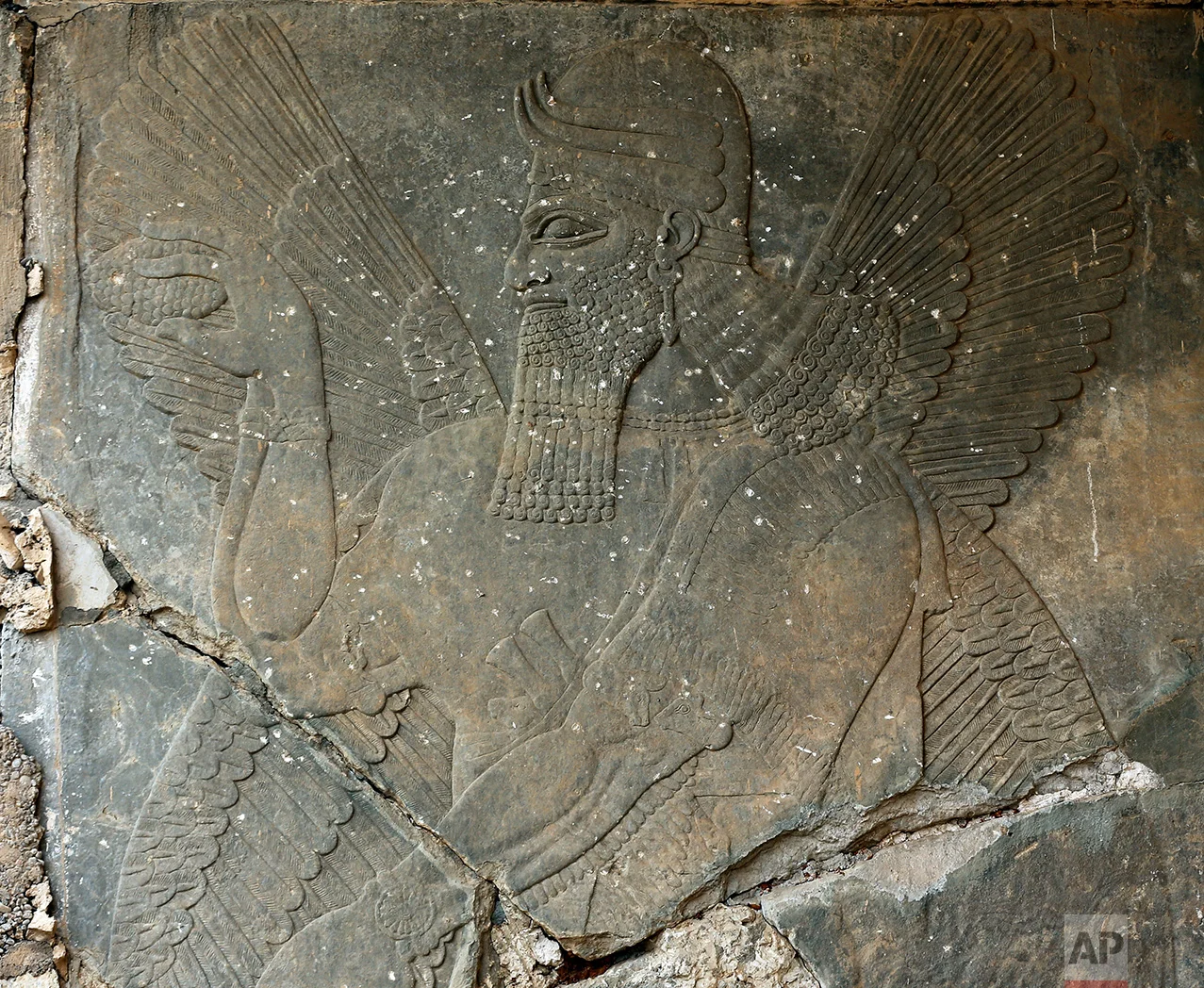 Carved stone slabs that were destroyed by Islamic State group militants are seen at the ancient site of Nimrud some 19 miles (30 kilometers) southeast of Mosul, Iraq in this Wednesday, Nov. 16, 2016 photo. Militants blew up and hacked apart much of the nearly 3,000-year-old city’s remains in 2015, destroying one of the Mideast’s most important archaeological sites. More than a month after the extremists were driven out, the site is still in danger, with the wreckage unprotected and vulnerable to being stolen. (AP Photo/Hussein Malla)