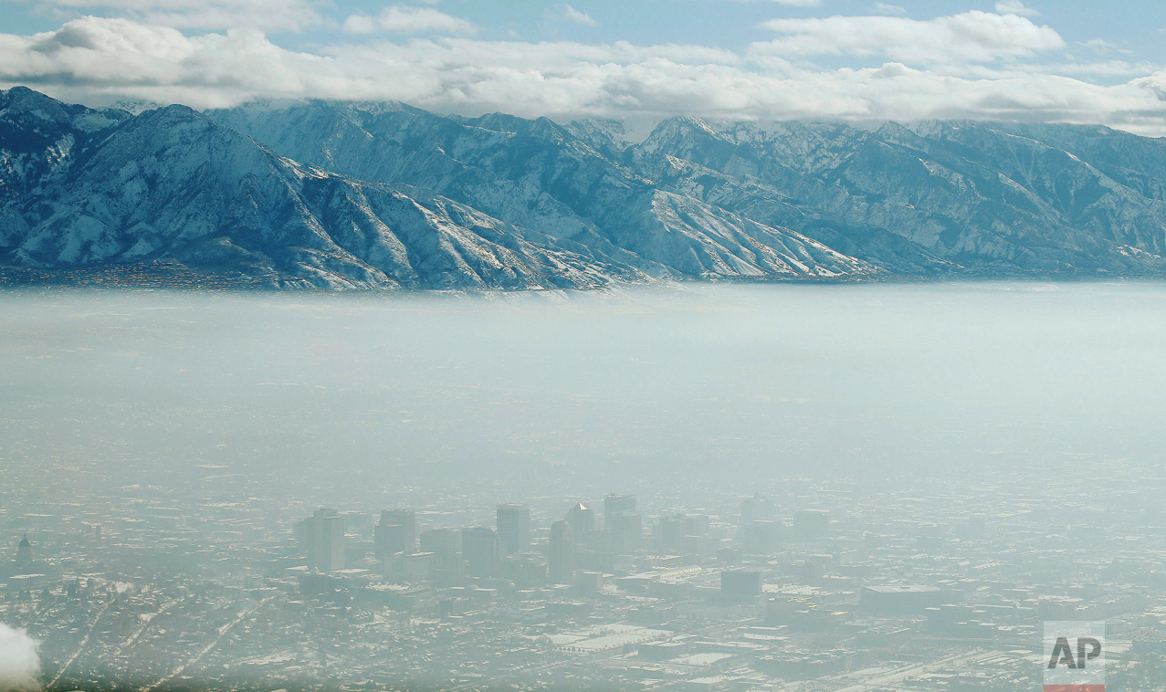 The downtown skyline of Salt Lake City, Utah is shrouded in haze during an inversion on Wednesday, Dec. 28, 2016. In the phenomenon, cold, stagnant air settles in the bowl-shaped mountain basins, trapping tailpipe and other emissions, creating a murky haze that engulfs the metro area. (Jeffrey D. Allred/The Deseret News via AP)