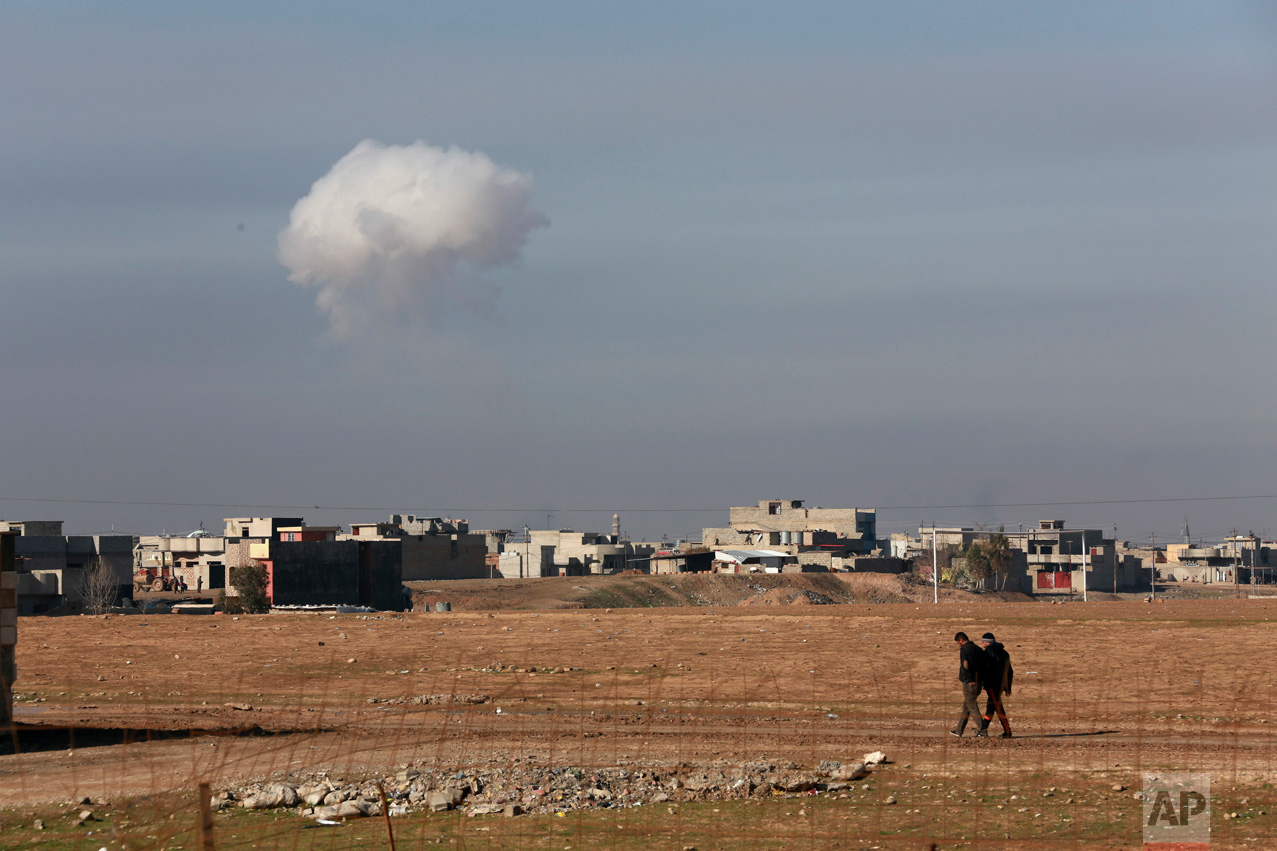 A plume of smoke rises as Iraqi elite counterterrorism forces fight Islamic State militants to regain control of the Quds neighborhood of Mosul, Iraq, on Friday, Dec. 30, 2016. Iraqi government forces launched a large-scale offensive in mid-October to retake Mosul, the last major urban center held by the extremist group in Iraq. The offensive, however, had stalled about two months later because of the presence inside Mosul of some one million civilians, stiff IS resistance and the lack of urban warfare experience among some Iraqi units. (AP Photo/ Khalid Mohammed)