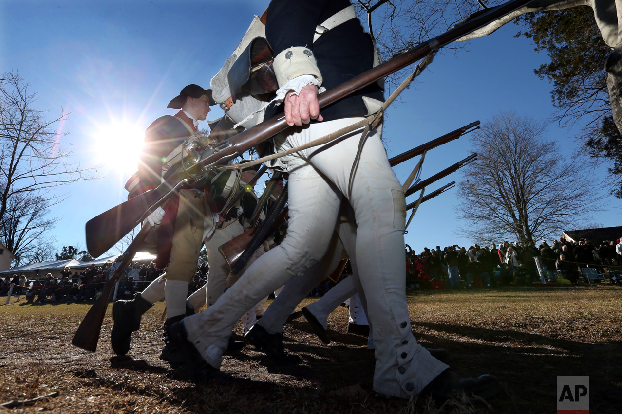 Participants march as they prepare to re-enact Gen. George Washington's Christmas 1776 crossing of the Delaware River, the trek that turned the tide of the Revolutionary War, in Washington Crossing, Pa., on Sunday, Dec. 25, 2016. (AP Photo/Mel Evans)