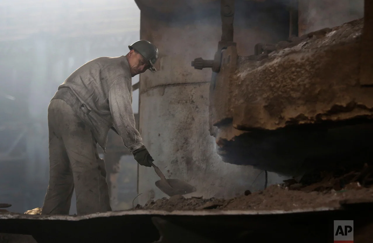 In this Saturday, Jan. 7, 2017 photo, a North Korean man works at the Chollima Steel Complex in Nampo, North Korea. North Korean officials and factory managers are scrambling to answer a call from leader Kim Jong Un for an all-out, nationwide effort to build up the country’s economy in 2017. The sprawling Chollima complex south of Pyongyang, the capital, is a focal point of North Korea’s effort to expand the economy and lift the nation’s standard of living. One of seven North Korean steel works, Chollima has more than 8,000 workers and is among the North’s showcase enterprises. (AP Photo/Wong Maye-E)