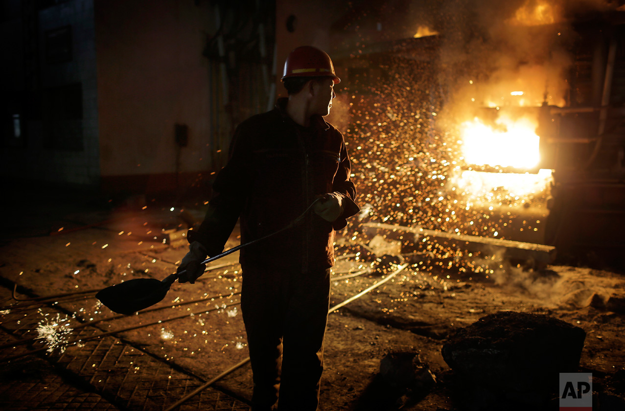 In this Saturday, Jan. 7, 2017 photo, a worker with a shovel stands near a furnace at the Chollima Steel Complex in Nampo, North Korea. North Korean officials and factory managers are scrambling to answer a call from leader Kim Jong Un for an all-out, nationwide effort to build up the country’s economy in 2017. The sprawling Chollima complex south of Pyongyang, the capital, is a focal point of North Korea’s effort to expand the economy and lift the nation’s standard of living. One of seven North Korean steel works, Chollima has more than 8,000 workers and is among the North’s showcase enterprises. Built by the Mitsubishi company during Japan’s colonial rule of the Korean Peninsula from 1910 to 1945, it was destroyed and then rebuilt. Production resumed soon after the Korean War ended with an armistice in 1953. (AP Photo/Wong Maye-E)