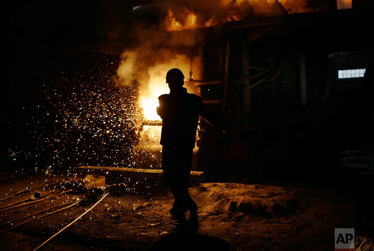 In this Saturday, Jan. 7, 2017 photo, a worker stands near a furnace at the Chollima Steel Complex in Nampo, North Korea. North Korean officials and factory managers are scrambling to answer a call from leader Kim Jong Un for an all-out, nationwide effort to build up the country’s economy in 2017. The sprawling Chollima complex south of Pyongyang, the capital, is a focal point of North Korea’s effort to expand the economy and lift the nation’s standard of living. One of seven North Korean steel works, Chollima has more than 8,000 workers and is among the North’s showcase enterprises. (AP Photo/Wong Maye-E)