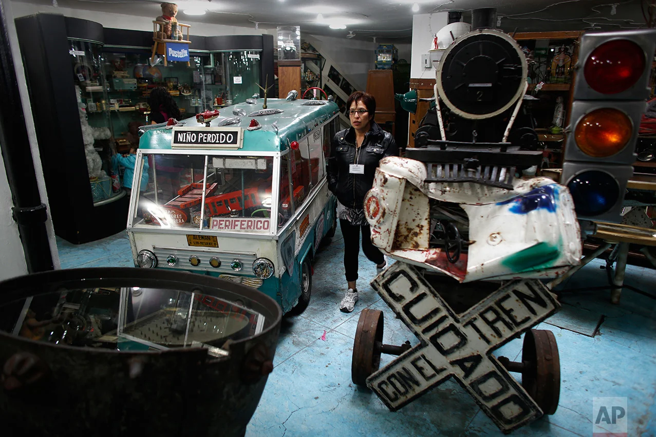 In this Jan.11, 2017 photo, visitors look at items displayed at the Mexico Antique Toy Museum in Mexico City. The Mexico Antique Toy Museum is a four story building filled with toys and objects that bring back childhood memories to the visitors that enter this unique monument to hoarding behavior. (AP Photo/Dario Lopez-Mills)