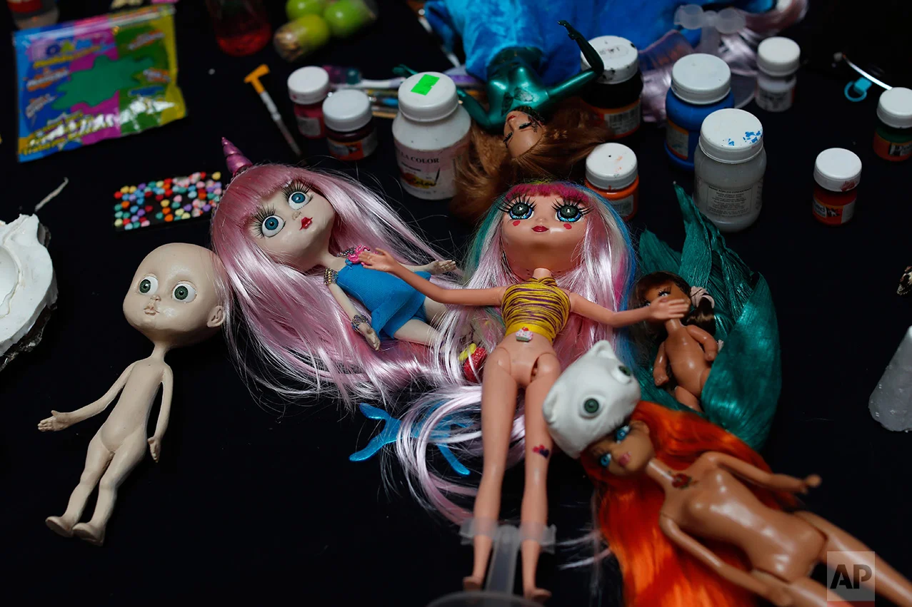 In this Jan. 6, 2017 photo, a doll making workshop takes place during a Barbie Doll temporary exhibit at the Mexico Antique Toy Museum in Mexico City. Several Barbie doll collectors teamed up to display their dolls in this museum. (AP Photo/Dario Lopez-Mills)