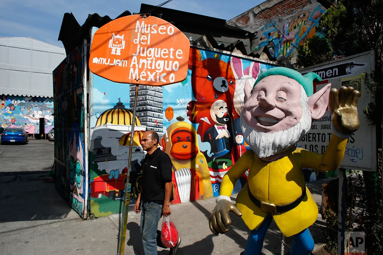 In this Jan. 11, 2017 photo, a man walks past the entrance to the Mexico Antique Toy Museum in Mexico City. The Mexico Antique Toy Museum is a four story building filled with toys and objects that bring back childhood memories to the visitors that enter this unique place. (AP Photo/Dario Lopez-Mills)