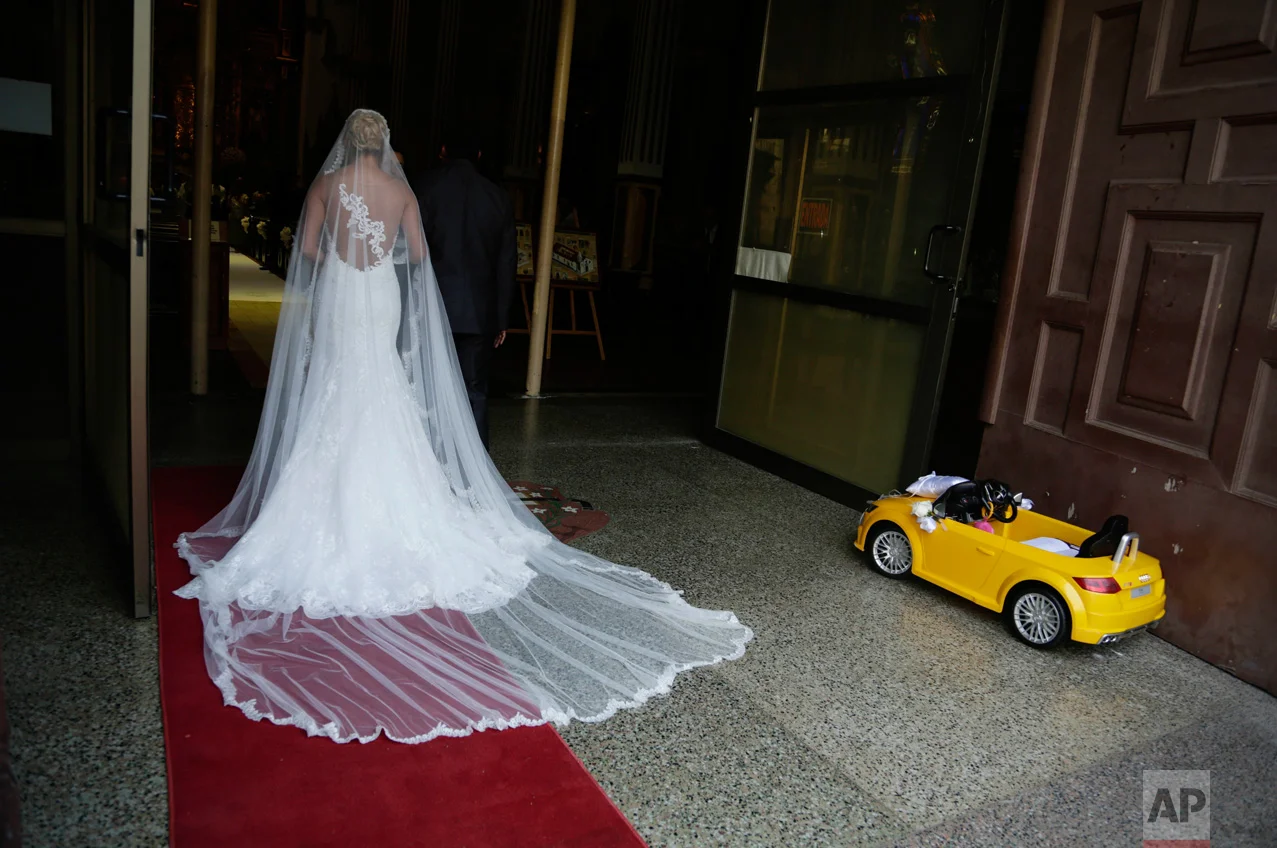 A bride waits for the procession to the altar at the San Jose or Altar de Oro church in the Casco Viejo neighborhood of Panama City on Saturday, Jan. 7, 2017. Casco Viejo is the old colonial district of Panama City, with cobblestone streets and colonial-era buildings. (AP Photo/Arnulfo Franco)